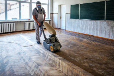 professional cleaner cleaning and shining the floor of the classroom